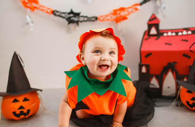 Smiling baby wearing Halloween costume