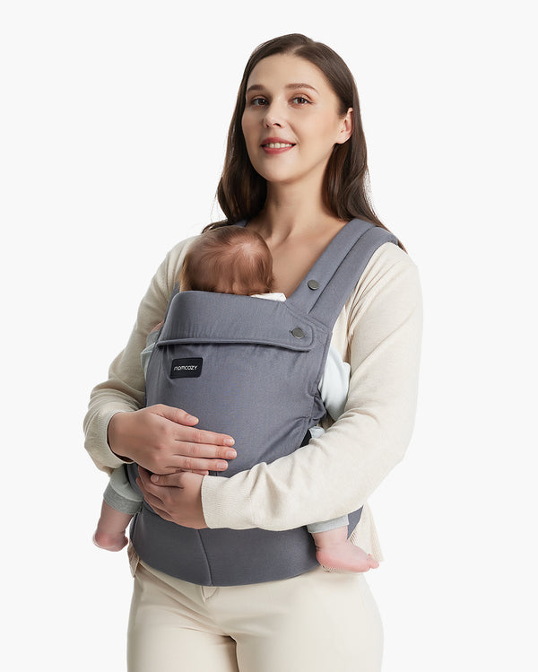 Mom holding baby in a grey Momcozy baby carrier suitable for newborn to toddler, showcasing comfort and support.