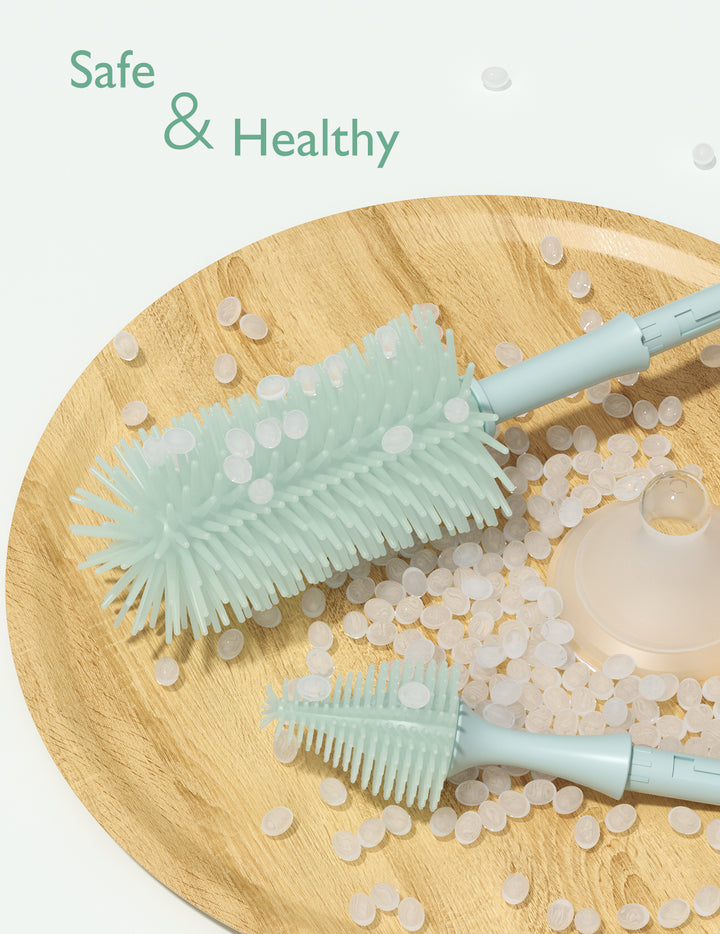 Momcozy bottle brush kit in teal color with cleaning pellets and funnel on a wooden tray.