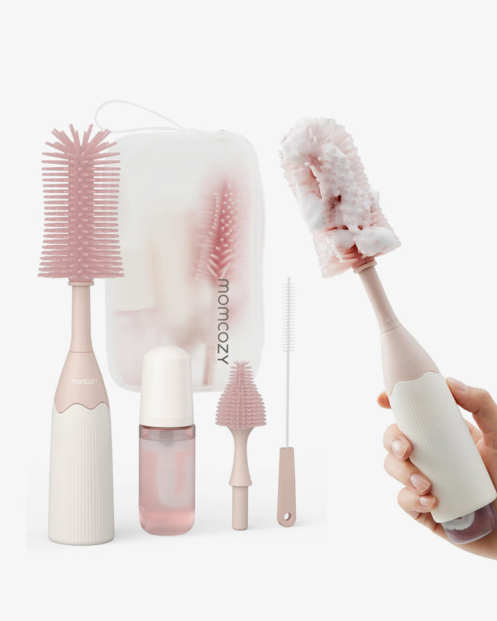 Momcozy 7-in-1 bottle brush kit with foaming cleaner, brushes, and accessories in pink.