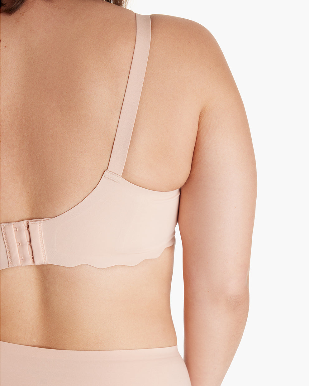 Woman models beige Jelly Strip Seamless Nursing Bra YN46, showing adjustable hook-and-eye & scalloped band for M9 Pump.