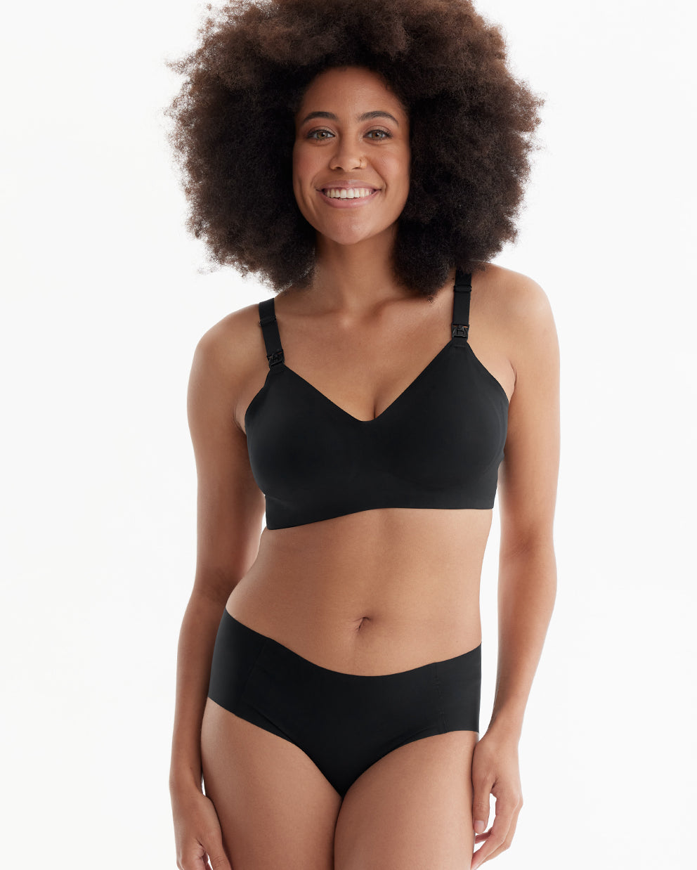Smiling model wears black Ultra Soft Seamless Nursing Bra YN21, featuring V-neck, M5 pump access, and comfortable fit.